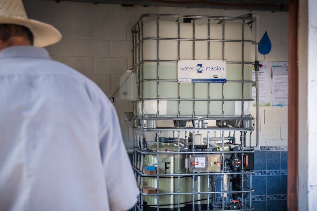 Man near living water treatment system