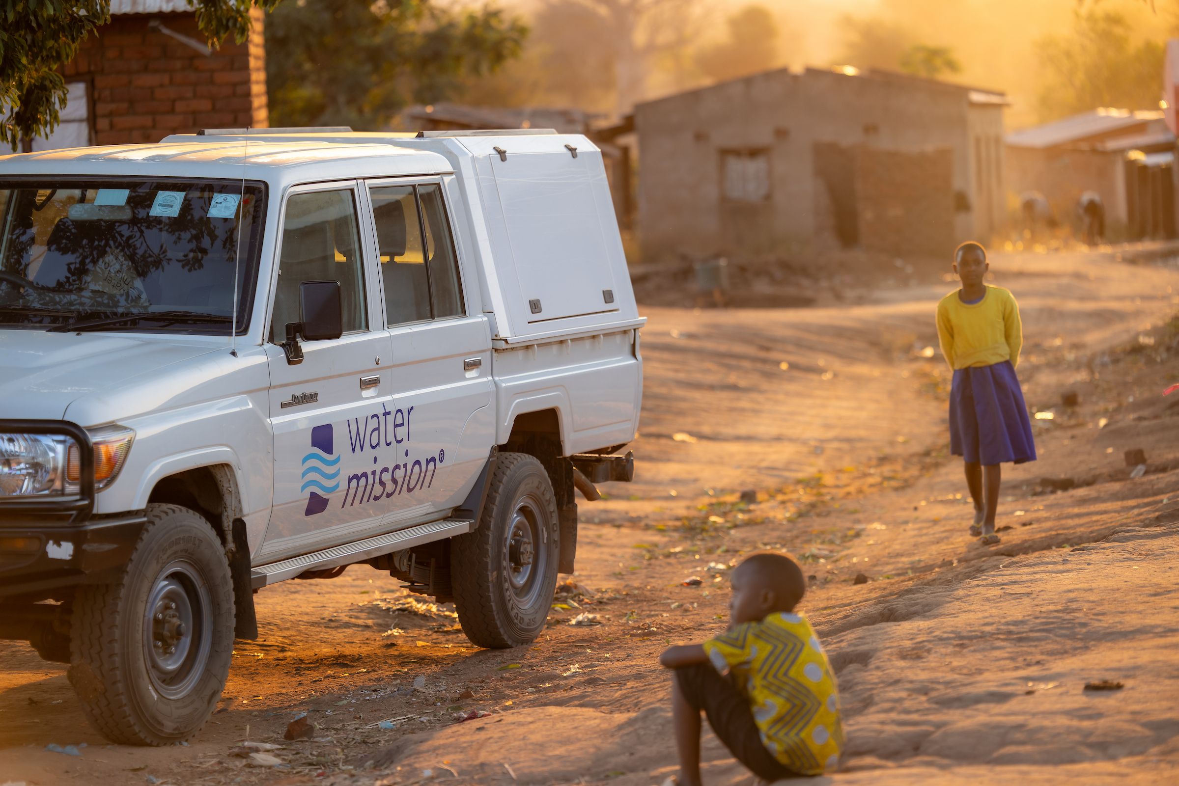 Water Mission creative examples photo of team members celebrating safe water in branded apparel