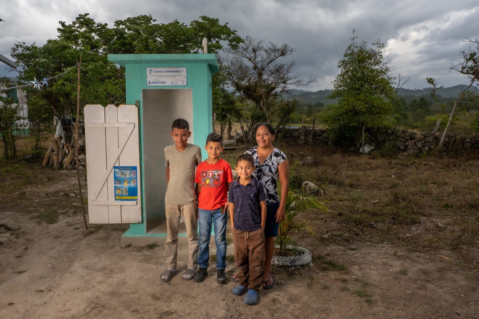 Family in front of healthy latrine