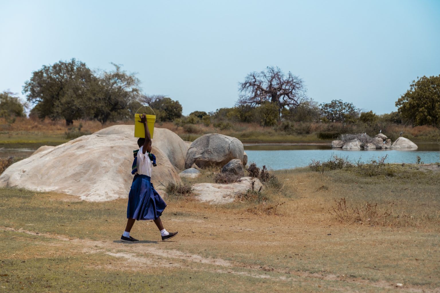 Woman carrying bucket