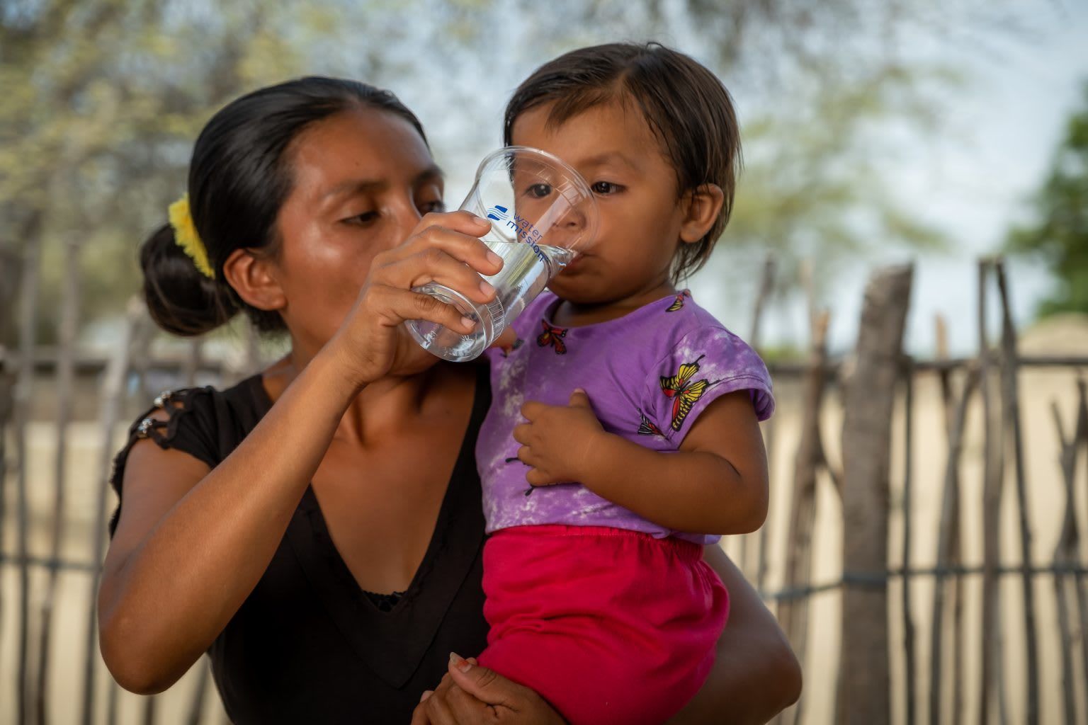 Woman and child drinking safe, clean water